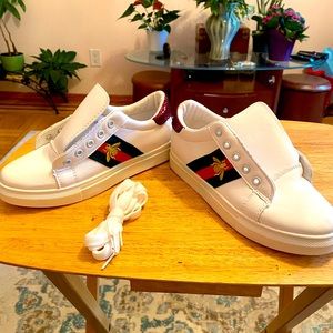 Brand new white tennis shoes with green and white stripes